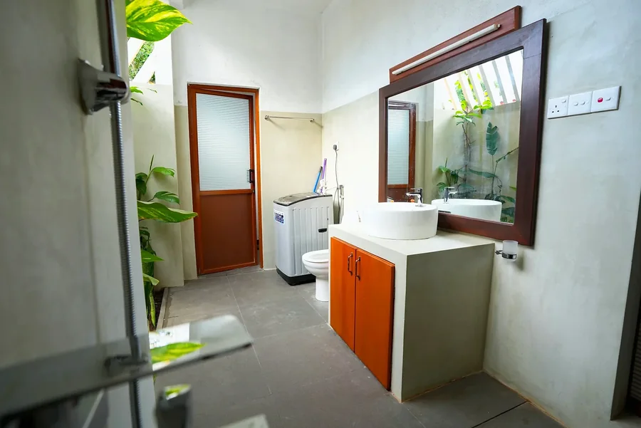 Salle de bains avec meuble vasque en bois et fenêtre sur le jardin — Syndeo Garden, Hikkaduwa